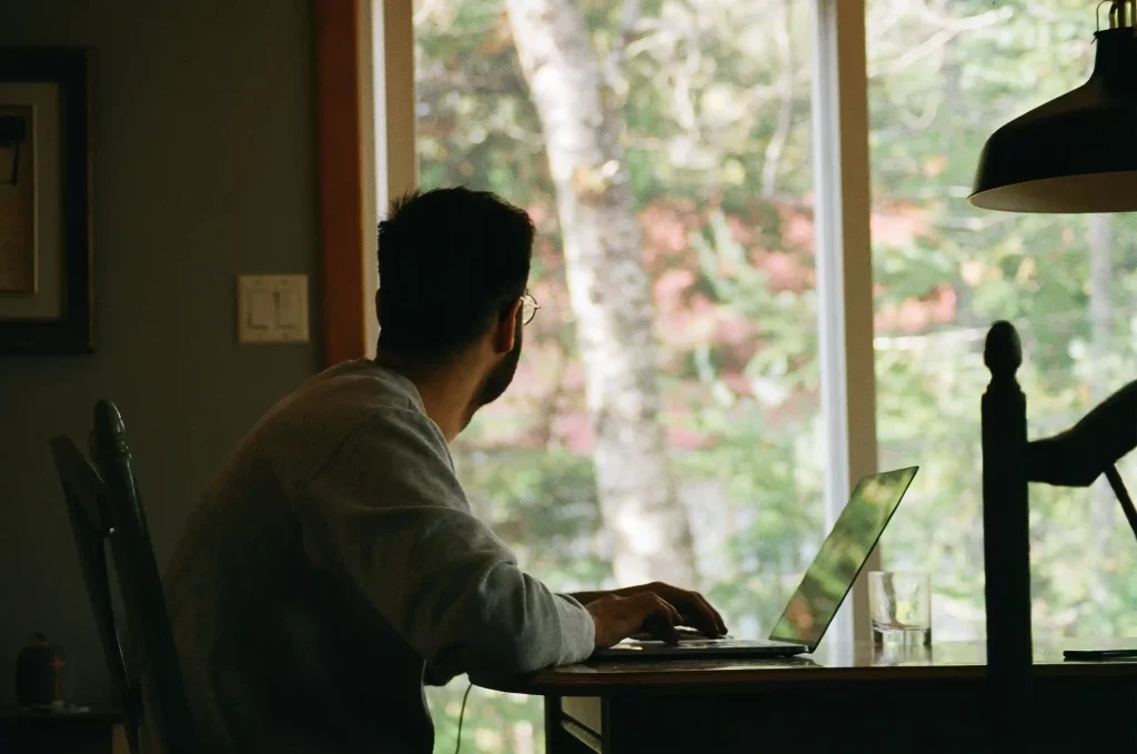 Person in home office gazing outdoors