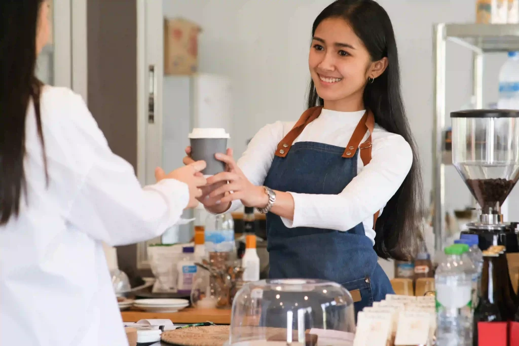 Server presenting coffee to patron