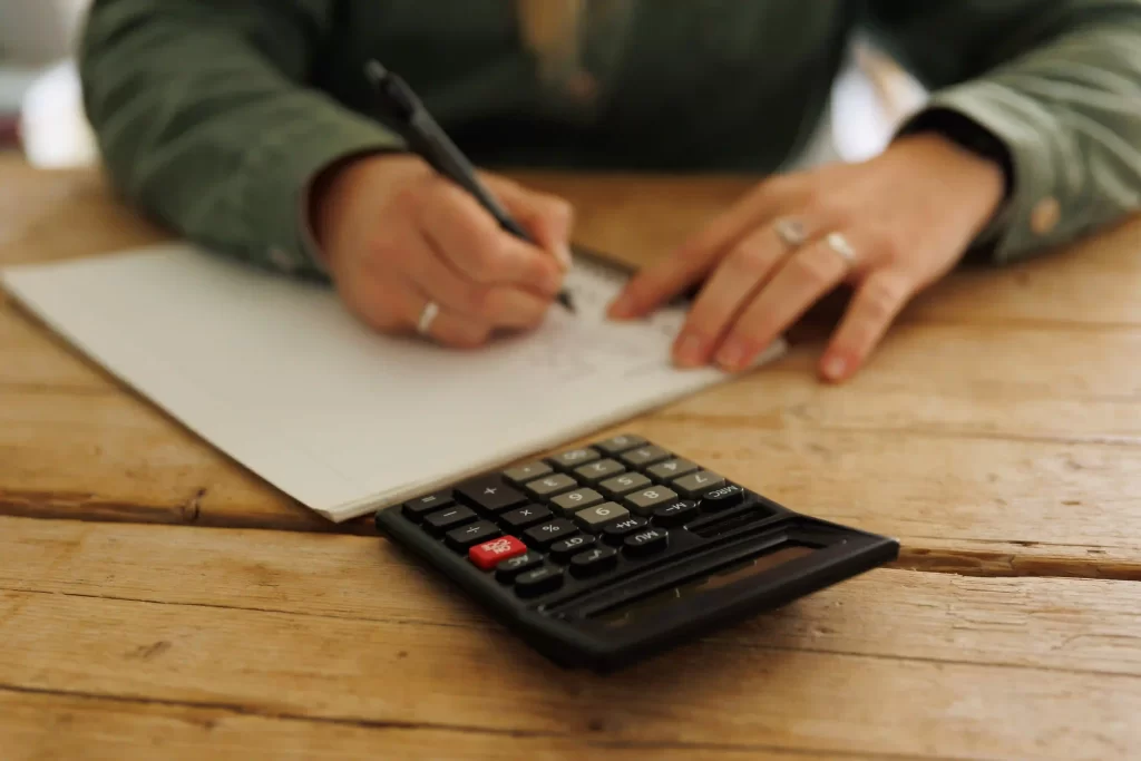 Person creating a budget, illustrating the 50/30/20 rule